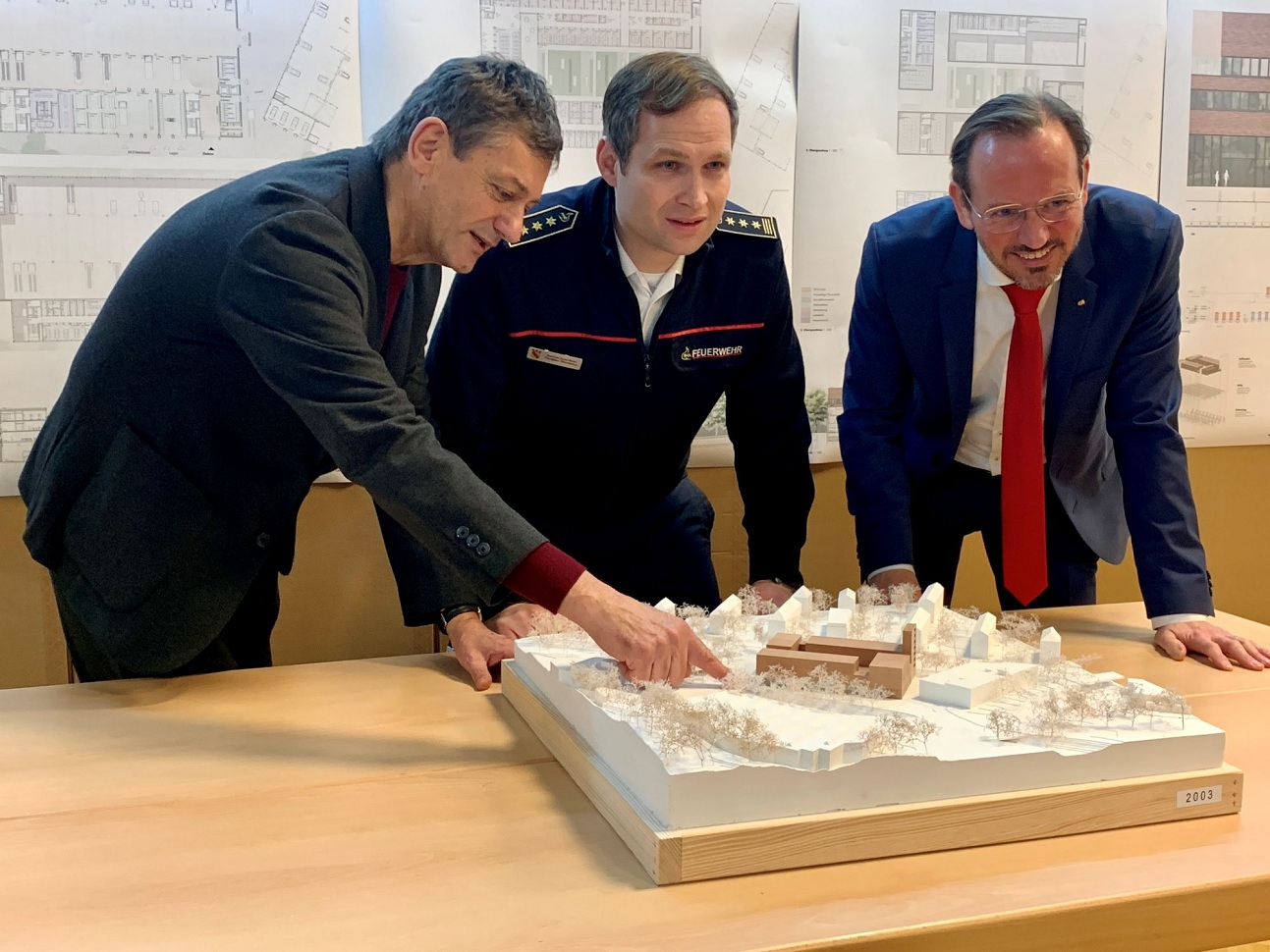 Preisgerichtsvorsitzender Prof. Zvonko Turkali, Feuerwehrchef Christian Pilardeaux und Erster Bürgermeister Alexander Wieland (von links) freuen sich über das Ergebnis des Planungswettbewerbs und präsentieren den Siegerentwurf.