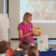 Petra Grobecker erzählt vor einer Klasse etwas zu einem vorgestellten Buch.