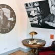 Ausstellungsbereich mit Bildern von Otto Flake, Tisch und Sessel.