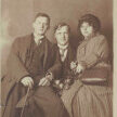 Otto Flake, Ernst Stadler und Minna Mai sitzen nebeneinander. Die Dame hält vier Rosen in den Händen.